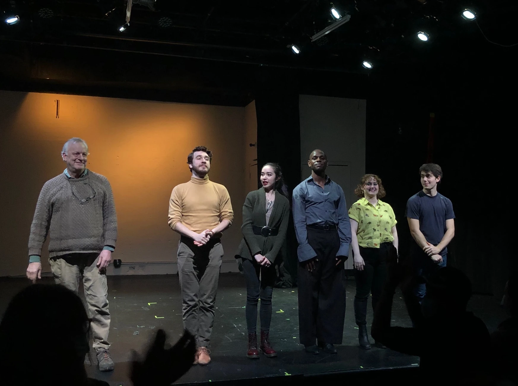 The cast lined up in front of the audience taking a bow